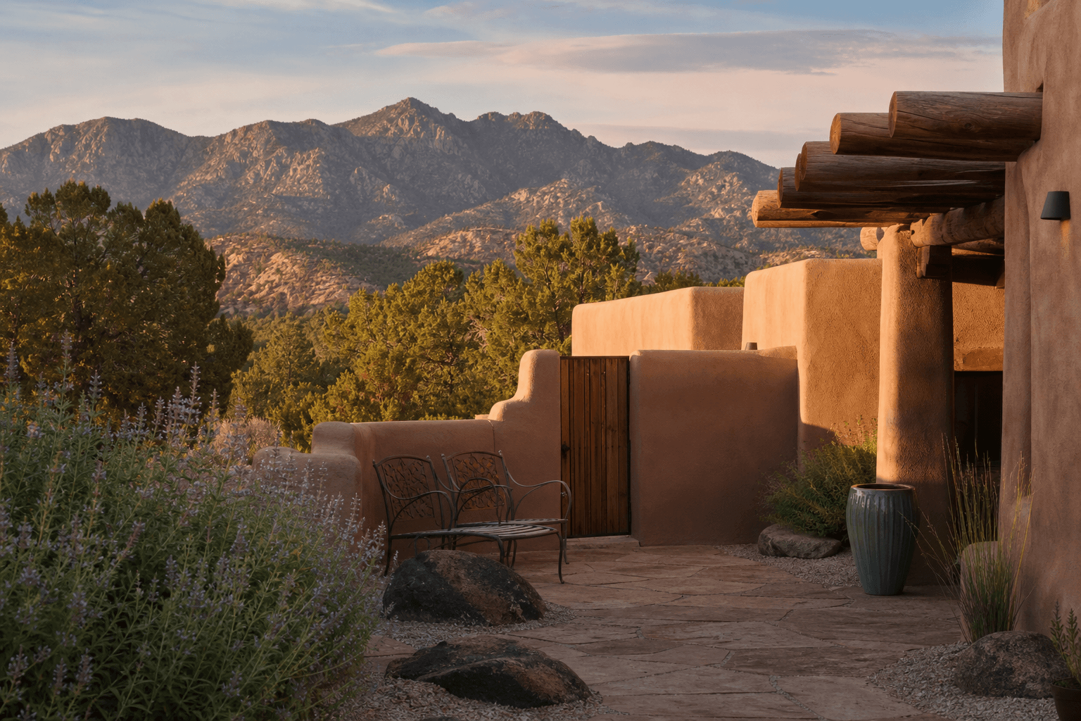 A quiet adobe retreat courtyard in the New Mexico high desert at golden hour with mountains beyond