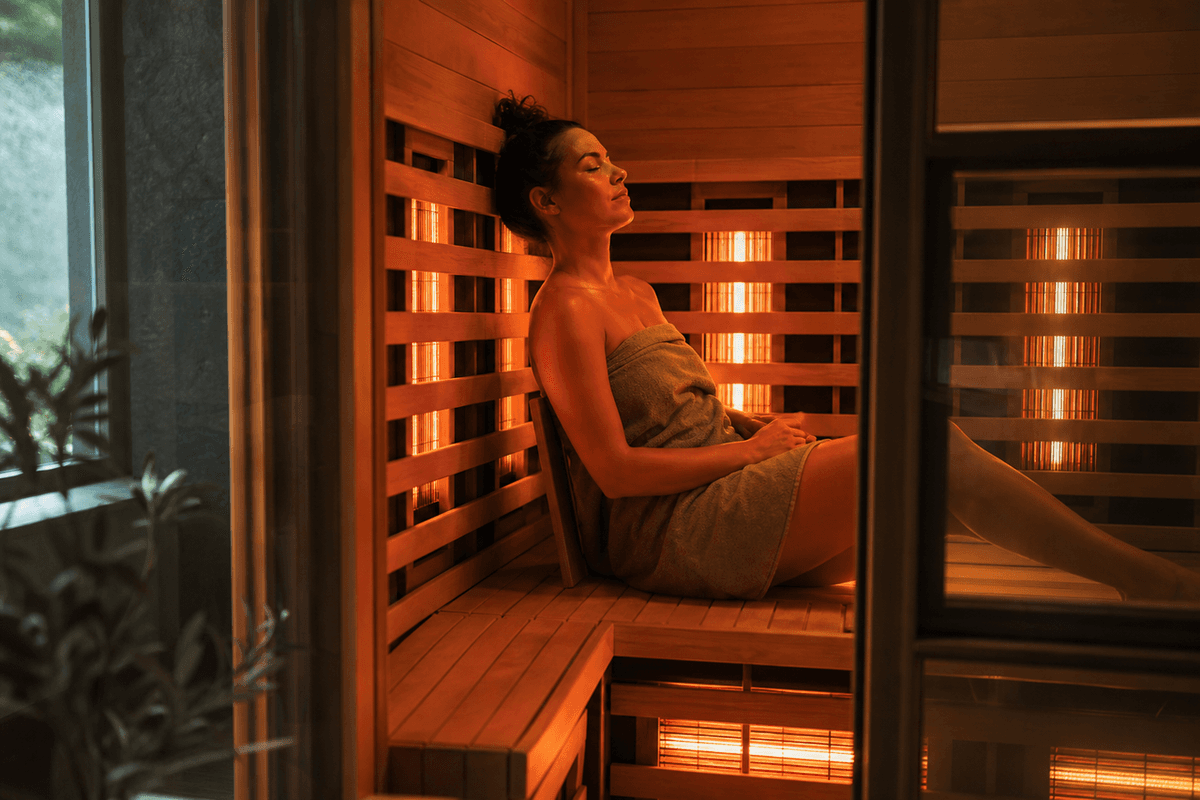 The warm glowing interior of an infrared sauna cabin with wooden benches
